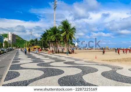 View of Leme beach and Copacabana beach with palms and mosaic of sidewalk in Rio de Janeiro, Brazil. Copacabana beach is the most famous beach in Rio de Janeiro. Sunny cityscape of Rio de Janeiro