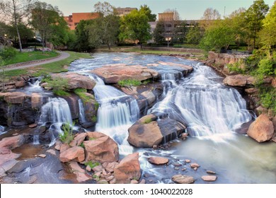 View from the Liberty bridge at a beautiful waterfall in the middle of Greenville South Carolina Falls park in the downtown. 