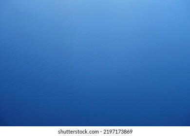 View of light blue fade to dark blue background showing the effect of sunlight on a defocused image of the ocean