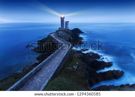 View of Lighthouse the Phare du petit minou in Plouzane, at sunset with red light , Brest , France, Brittany
Beautiful sunset seascape.