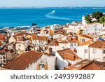 View of Lisbon old town Alfama district with houses clay orange roofs from viewpoint Portas do Sol, Lisbon, Portugal