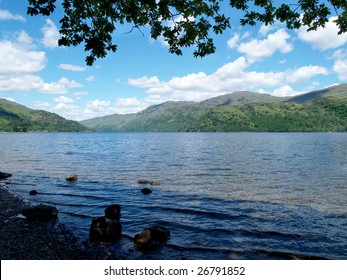 View Of Loch Lomond From Shoreline Under Trees