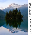 View of a lone island on Packwood Lake in the Cascade Mountains with Johnson Creek in the background