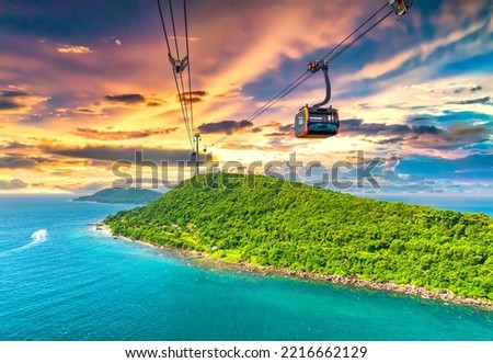 View of longest cable car ride in the world, Phu Quoc island, Vietnam, sunset sky. Below is seascape with tropical islands and boats.