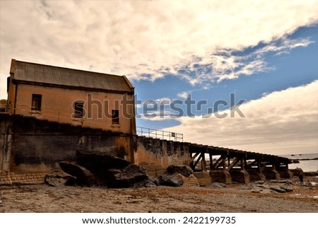 A view looking up at the abandoned lifeboat station from the beach.