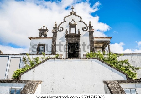 A view looking up at the Chapel of Our Lady of Peace across Ribeira Seca on the island of San Miguel in the Azores in summertime