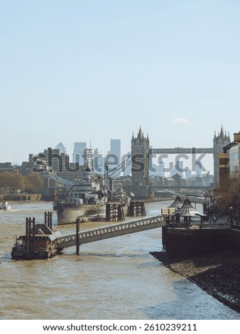 A view looking down the Thames River in London at Tower Bridge and HMS Belfast
