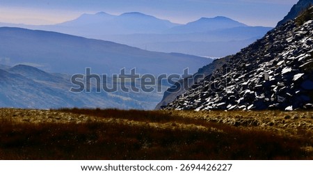 View looking down the valley toward Trawsfynydd from Manor Quarry near Cwt y Bugail, Blaenau Ffestiniog, with layered mountain silhouettes and slate scree in Snowdonia National Park (12.10.25).