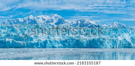 A view looking up at the ice wall of the snout of the Hubbard Glacier in Alaska in summertime