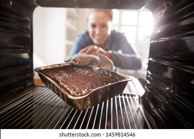 View Looking Out From Inside Oven As Woman Burns Dinner