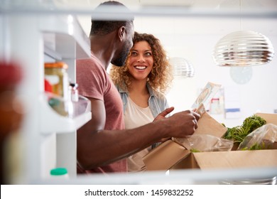 View Looking Out From Inside Of Refrigerator As Couple Unpack Online Home Food Delivery - Powered by Shutterstock