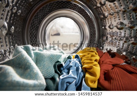 View Looking Out From Inside Washing Machine Filled With Laundry