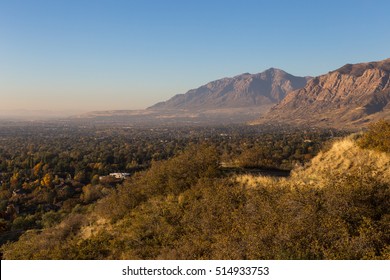 View Looking Out Over The City Of Ogden Utah With The Mountains In The Background.