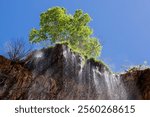 The view looking up as water cascades off of the travertine natural bridge at Tonto Natural Bridge State Park near Payson, Arizona.