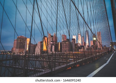 A View Of Lower Manhattan Skyline From From Brooklyn Bridge At Sunrise