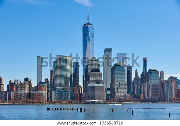 A view of\
the Lower Manhattan Skyline as seen from the Newport, Jersey City\
Waterfront on cloudless day. Liberty Tower anchors the view. The\
Hudson River is in the\
foreground.