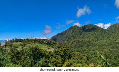 A View Of Lush Green Hills And Clear Blue Skies