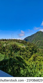 A View Of Lush Green Hills And Clear Blue Skies