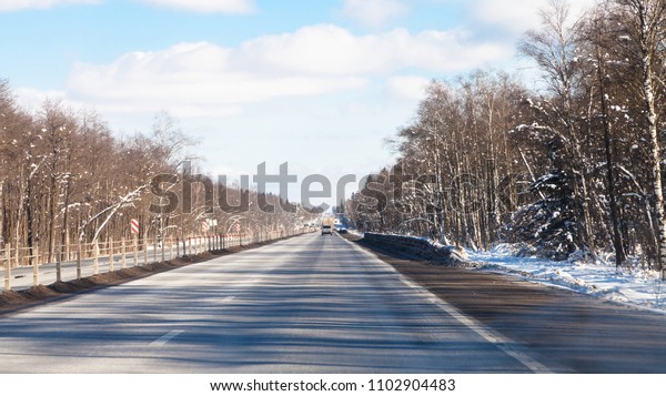 view of\
M1 highway (Russian route M1, Belarus Highway, European route E30)\
in Smolensk oblast of Russia in winter\
day