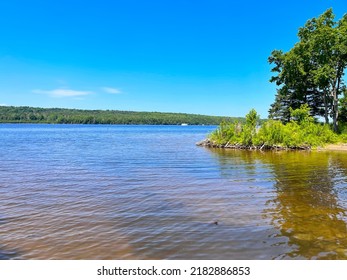 View of Mactaquac park on the Saint John River with a beaver damn overgrown with vegetation near Fredericton New Brunswick,. Canada