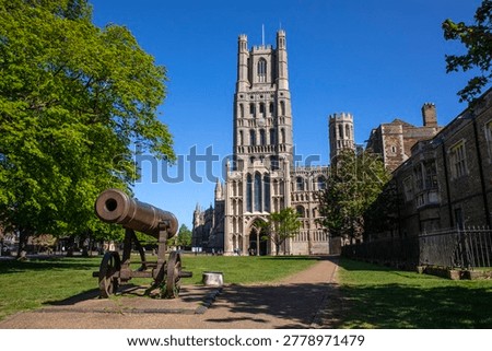 View of the magnificent Ely Cathedral and the captured Russian Cannon, in the city of Ely, in Cambridgeshire, UK. 