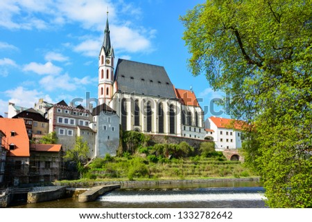 A view of the majestic baroque Church of St. Vitus in Cesky Krumlov, South Bohemia, Czech Republic, from the Vltava river. The church is one of the major landmarks of the town, along with the castle