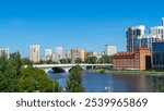 View of Makarovsky bridge and quarter on embankment of city pond, Iset River, Yekaterinburg, Russia. View from Boris Yeltsin Presidential Center.