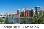 View of Makarovsky quarter and bridge on embankment of city pond, Iset River, Yekaterinburg, Russia. View from Boris Yeltsin Presidential Center.