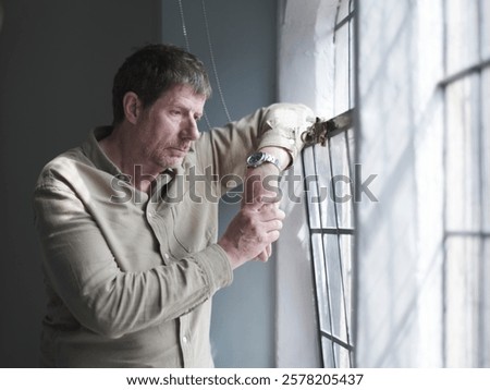 View of Man looking through window