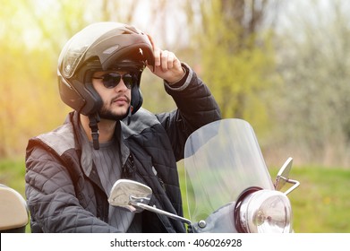 View Of A Man On The Motorcycle With A Helmet On.Lens Flare