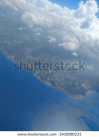 view of manado city from the plane after takeoff, on December 30, 2023