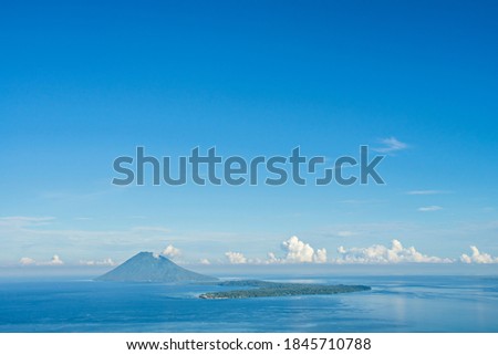 View of Manado Tua mountain and Bunaken Island from Tumpa Mountanin. Manado Tua Mountain and Bunaken Island is landmarks and popular tourist destination in Manado, Indonesia.