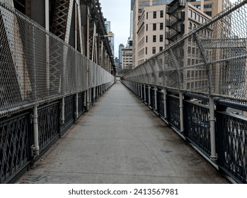 view of manhattan bridge pedestrian  walkway (overpass over hudson river between brooklyn and manhattan) cycling, biking, walking, jogging path in new york city (nyc scenic tourist destination) - Powered by Shutterstock