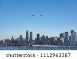 View of the Manhattan skyline, New York from New Jersey with military transport helicopters in the sky