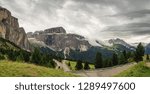 View of Marmolada and Sella Group from Sella Pass in cloudy day, Dolomites, Italy