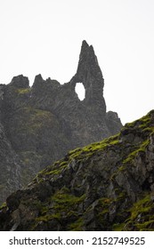 A View Of Massive Black Rocks Covered With Fresh Green Moss On A Spring Or Summer Day