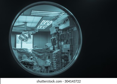 View Of Medical Equipment Through The Operating Room Door Round Window. /cyanotype//