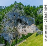 A view of the medieval castle built into the cliff face at Predjama, Slovenia in summertime
