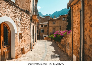 View of a medieval street in the Old Town of the picturesque Spanish-style village Fornalutx, Majorca or Mallorca island.