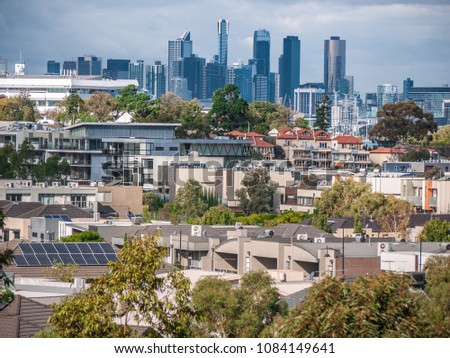 View of Melbourne's suburban houses and residential modern apartments with skyscrapers in CBD as background. City of Maribyrnong, VIC Australia.