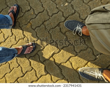 view of Mens with footwear on paving blocks