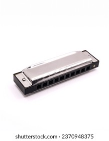 A view of a metal harmonica on a white background