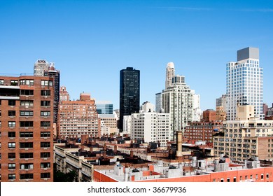 View of metropolitan city hirise skyscraper rooftops under a deep blue spring or summer sky. Upper East Side tall buildings viewed from above in Manhattan, New York City.
