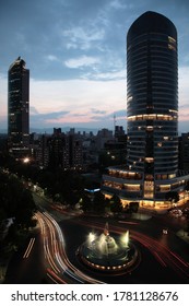 View Of  Mexico City Skyline With Diana The Huntress Fountain And Car Lights Trails On Promenade Of The Reform During Sunset, Mexico.