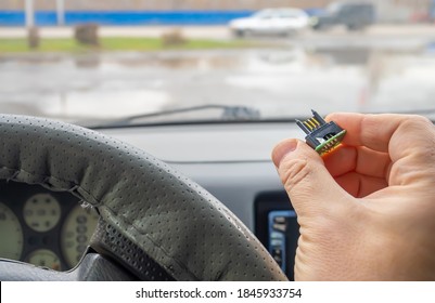 View Of A Microchip With Electric Gold Plated Contacts In The Car Driver's Hand