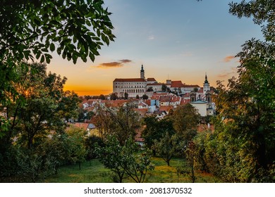 View of Mikulov with beautiful Baroque castle on the rock at sunset,south Moravia,Czech Republic.Dominant of town skyline.Czech Chateau in Palava wine region.Picturesque town among vineyards.