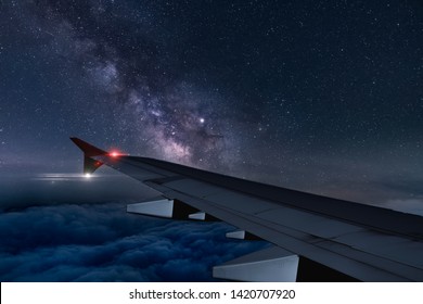 View of milky way from plane window while flying at night - Shutterstock ID 1420707920