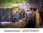 View of the millpond, waerfall, flume, and waterwheel at Historic Yates Mill County Park in Raleigh, North Carolina.