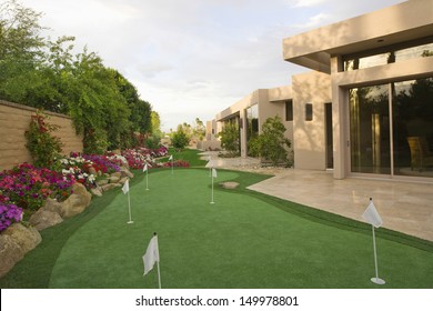 View of mini golf course in garden by luxury house - Powered by Shutterstock