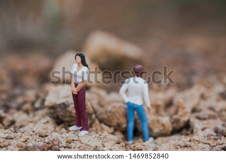 View of miniature couple, having a conflict.